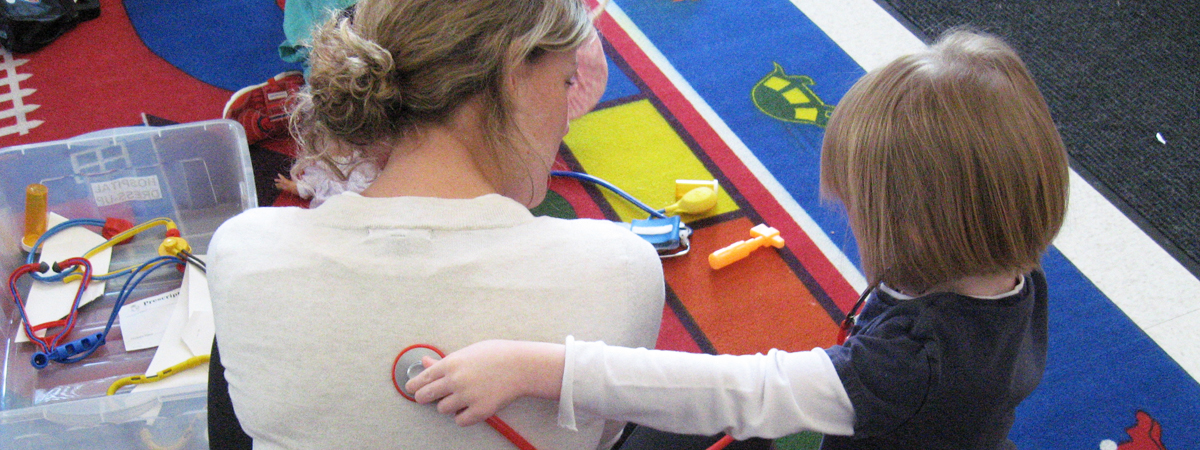 Todler at play with her teacher.